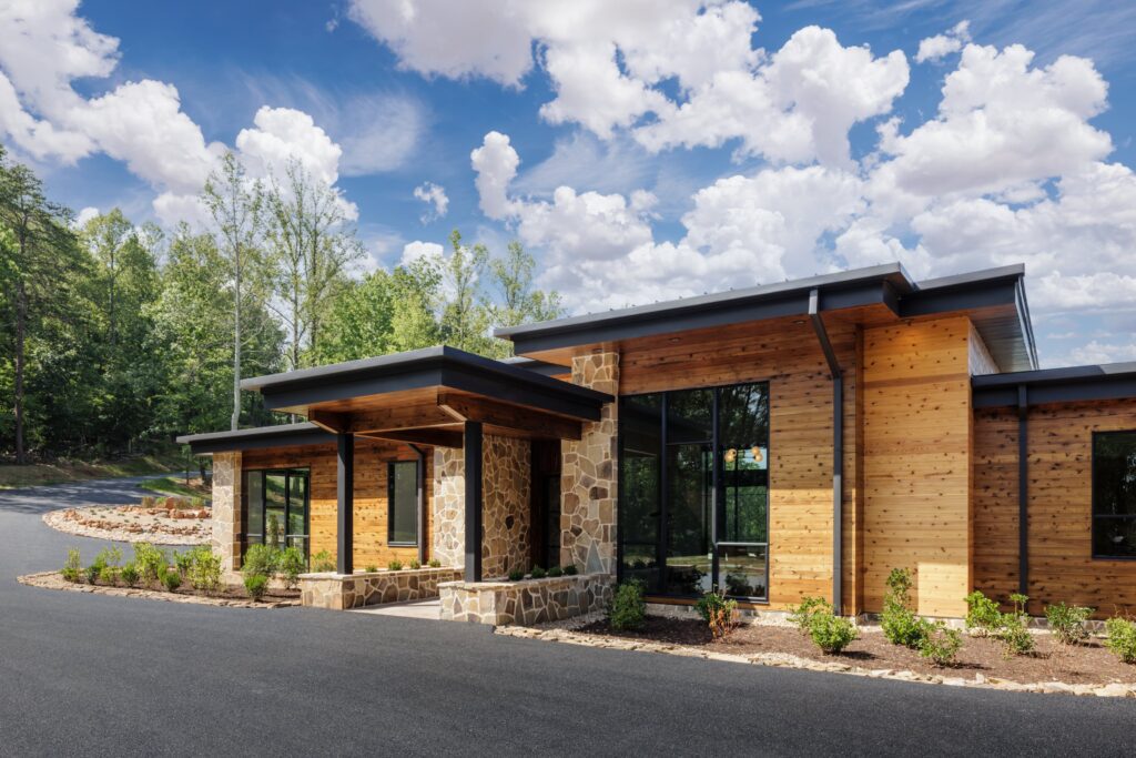 front exterior of the organic modern home showcasing the natural materials including locally sourced stone and cedar wood.